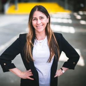 Florencia San Martín standing with her hands on her hips in a building.