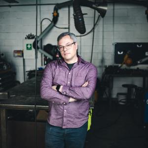 Wes Heiss standing in his studio.