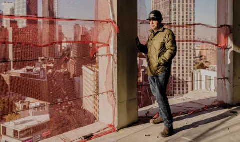 Jared Della Valle in his Alloy Block project leaning on the wall.