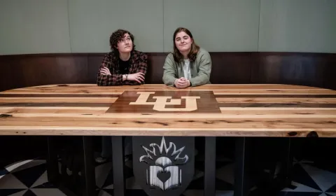 Sonja Hackenmueller '26 and Annie Oatman '25 pose at the pub table they helped create through Lehigh Design Labs.