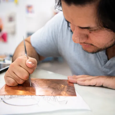 Student doing artwork.