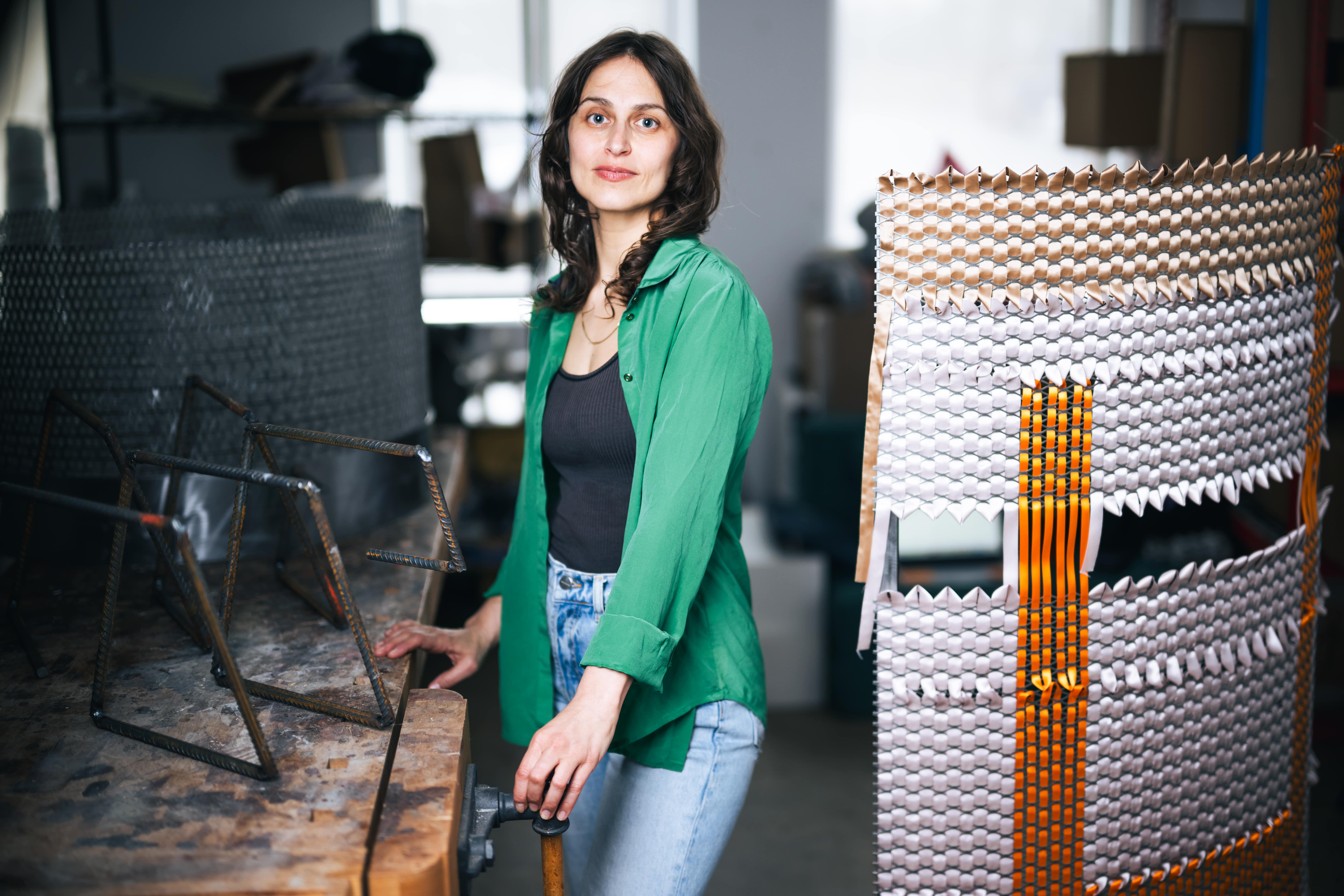 Alina Tenser standing in her studio.