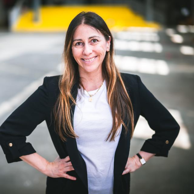 Florencia San Martín standing with her hands on her hips in a building.