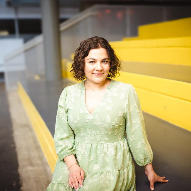 Katie Fritz sitting on yellow stairs.