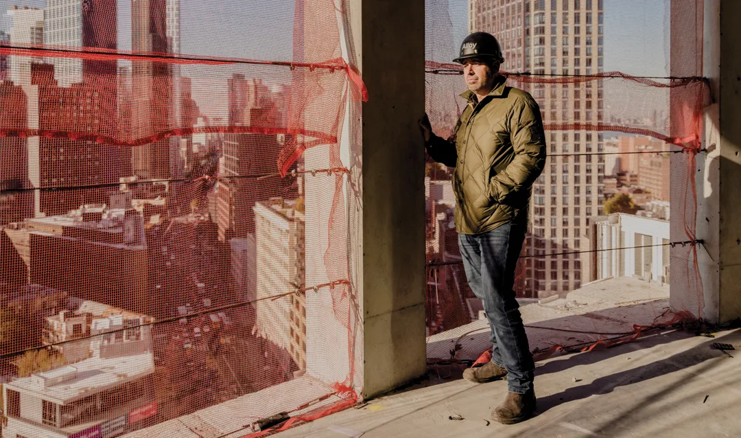 Jared Della Valle in his Alloy Block project leaning on the wall.
