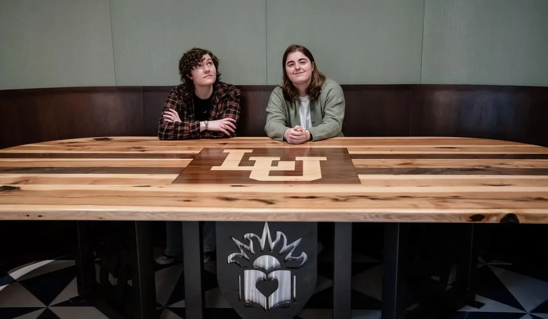 Sonja Hackenmueller '26 and Annie Oatman '25 pose at the pub table they helped create through Lehigh Design Labs.