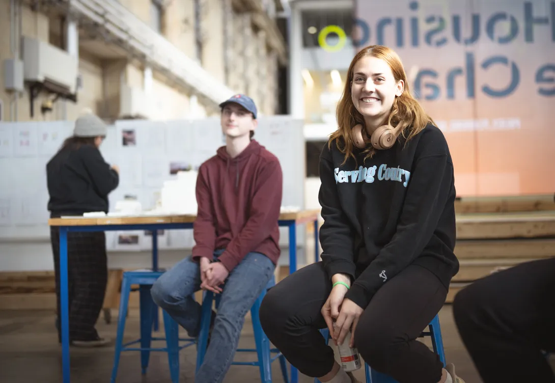 Three students gathered in the department spaces in the high bay studios