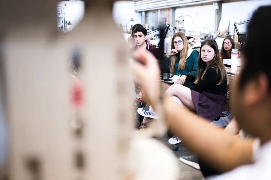 Three students gathered in the department spaces in the high bay studios